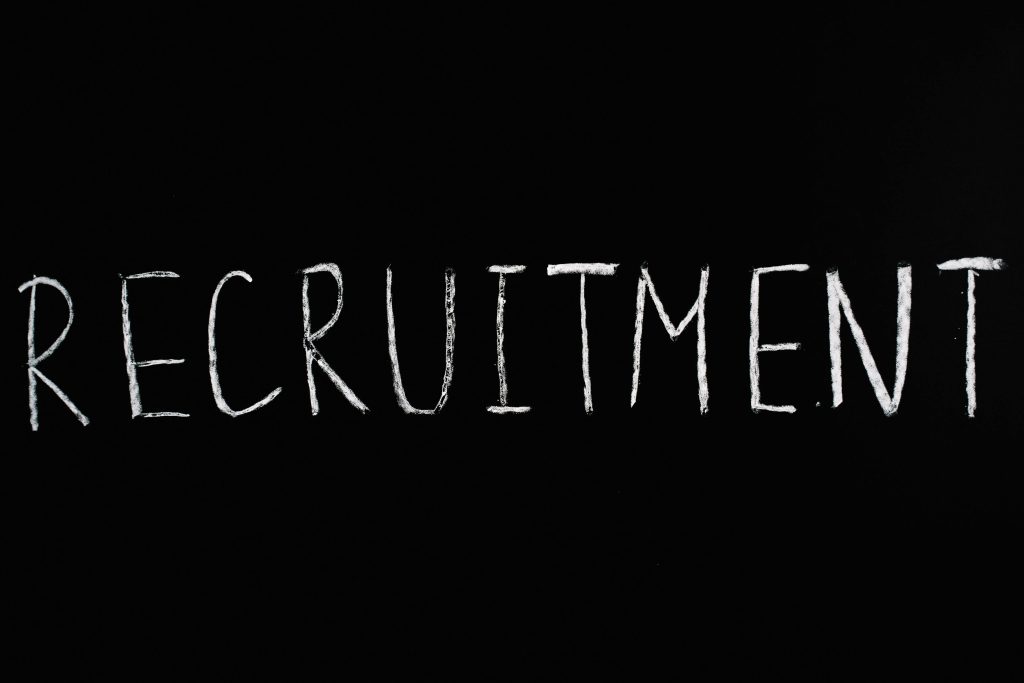 pexels-photo-5598299-5598299 Chalk-written 'RECRUITMENT' on a black chalkboard, ideal for HR and hiring themes.